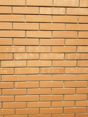 The modern texture of an orange brick wall is the background material of industrial construction