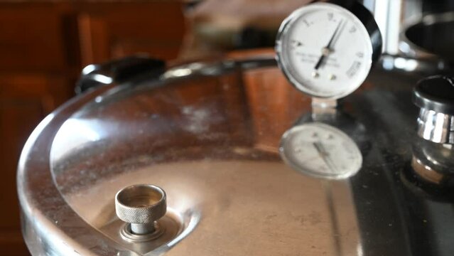 pressure cooker gauge and relief valve with steam and water bubbling out