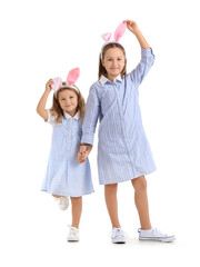 Little girls in bunny ears on white background. Easter celebration