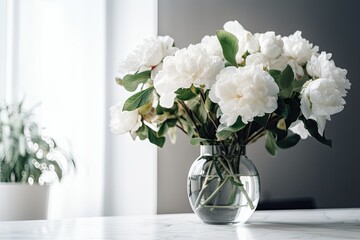 White flowers in a vase on a white background in a room. current interior decoration. Generative AI © AkuAku