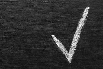Check mark on blackboard, top view