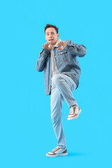 Fototapeta premium Scared young man on light blue background
