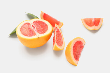 Fototapeta na wymiar Pieces of ripe grapefruit on white background