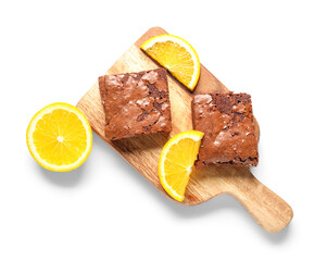 Wooden board with pieces of tasty chocolate brownie isolated on white background