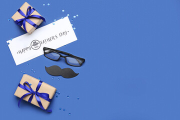 Card with text HAPPY FATHER'S DAY, eyeglasses, paper mustache and gifts on blue background