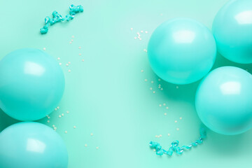 Frame made of blue balloons, ribbons and serpentine on color background