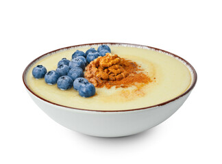 Bowl of tasty semolina porridge with blueberry and nuts on white background