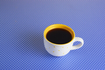 yellow cup of coffee on a blue background