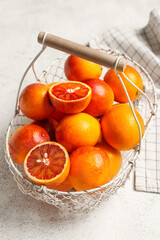 Basket with tasty blood orange fruits on white background
