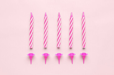 Birthday candles on pink background