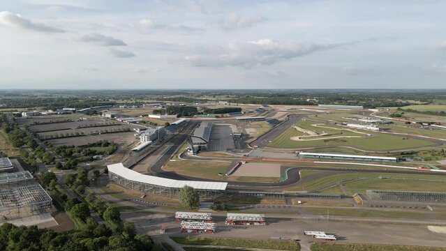 Aerial view rising above Silverstone motorsport race track and rural British landscape