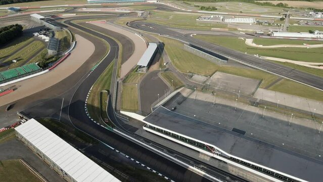 Aerial view reversing over Silverstone motorsport international pit straight British racetrack F1 circuit
