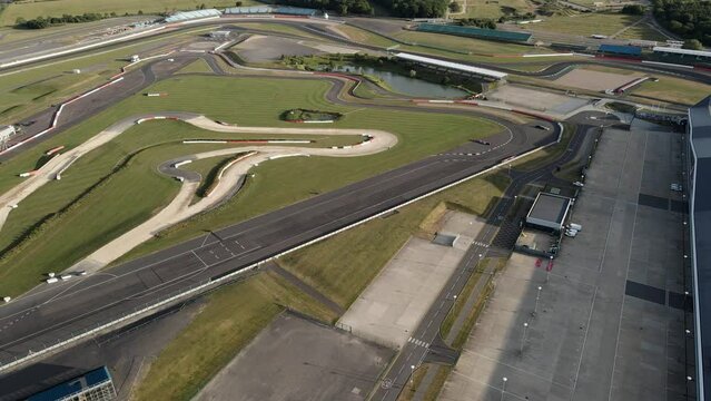 Aerial view orbiting Silverstone motorsport International pit strait on British race track circuit, England