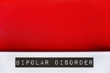 Red wall background with text BIPOLAR DISORDER on blur foreground, concept of serious shifts in...