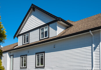 Facade of a house with nice windows in the blue sky background. Beautiful Home Exterior. Real Estate Exterior