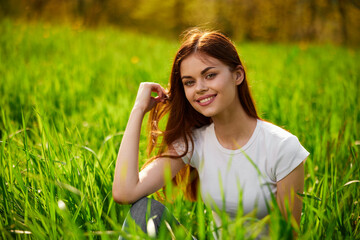 Beautiful young woman close up portrait among green cereal grass