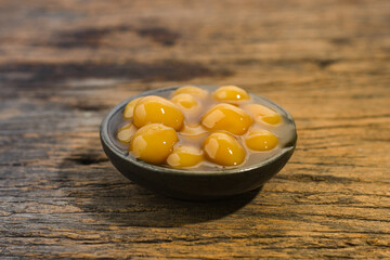 Bubur candil or bubur biji salak served on small ceramic bowl, Candil is an Indonesian food in the form of porridge made from glutinous rice flour, brown sugar and coconut milk.