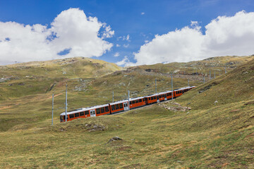  train on the background of the Matterhorn mountain in the Swiss Alps