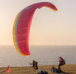 Red and yellow paraglider at sunset