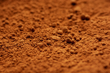 Cocoa powder top close up background. Selective focus