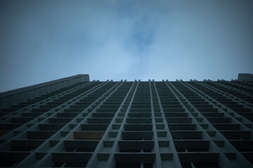 High-rise. Skyscraper and gray sky. Urban development. Details of city.