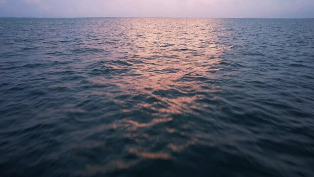 Sunset fly over the waters of the Gulf of Mexico. Located in Cancun, Mexico. Aerial 4K drone video