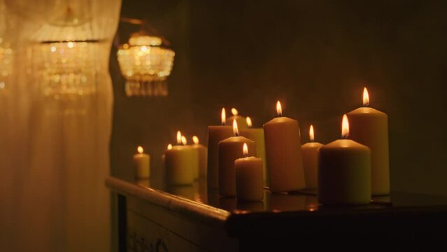 The witch conjures up a mystic rite with black candles in a dark background, evoking voodoo magic and paganism. The close-up captures the intensity of the magic ritual