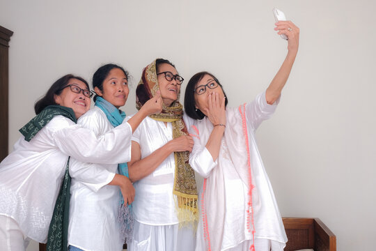Group of women in white selfie.