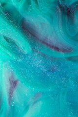 Photo of beautiful mixtures of blue colorful substances in the deep space. Abstract texture of colorful splashes. Expressive swirls.