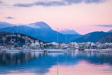 Fototapeta premium Sunrise and alpine glow on the mountains of the Tramuntana from port de Pollenca Majorca Spain