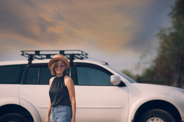 beautiful woman standing in front of suv car with toothy smiling happiness face
