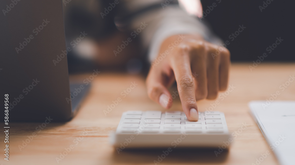 Poster businessman calculating figures in company financial documents with a calculator,analysis of company