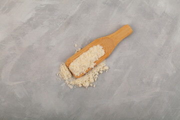 Food additive E234 in wooden scoop. Nisin powder inhibits yeast growth, effective drug against mold, natural antimicrobial antifungal agent, preservative in food industry