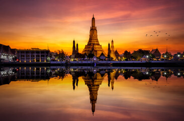 The famous Buddhist Temple Wat Arun during dusk with reflections in the Chao Phraya Rriver, Bangkok, Thailand