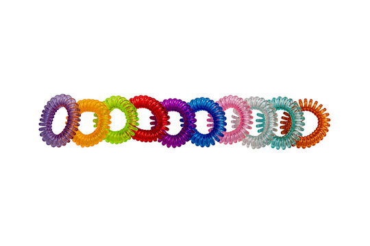 Hair care tools isolated. Close-up of multicolored elastic spiral scrunchies or hair bands for women hairstyling. Clipping path. Tools from hairdresser and beauty salon.