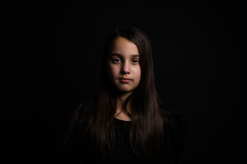 Fototapeta premium Closeup portrait of happy little girl isolated on black background