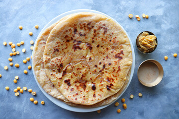 Puran Poli is an Indian sweet flatbread stuffed with chana dal, jaggery, ghee and cardamom and is...