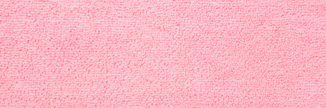 Light pink dry soft microfiber rag background. Closeup. Pastel color. Wide banner. Empty place for text. Top down view.