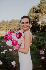 young woman with  pink peonies 