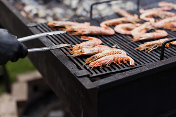 Cooking seafood shrimp on barbecue grill