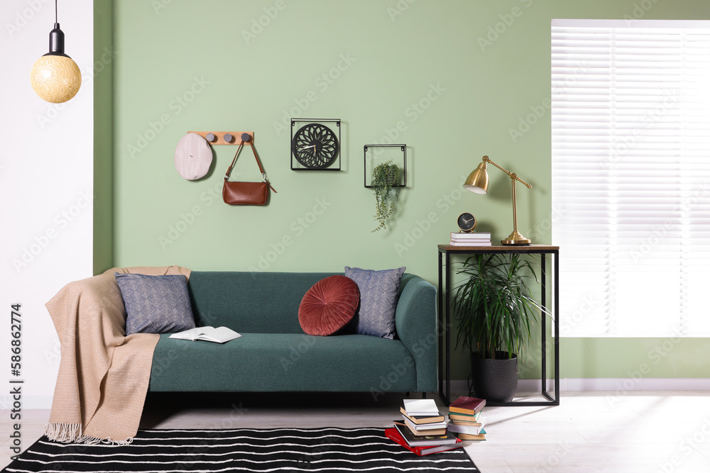 Canvas Prints Stylish interior with comfortable sofa, blanket and cushions near console table