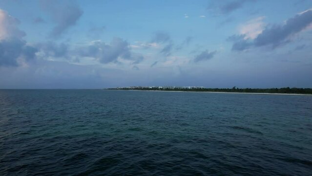 Sunrise fly over the waters of the Gulf of Mexico. Located in Cancun, Mexico. Aerial 4K drone video