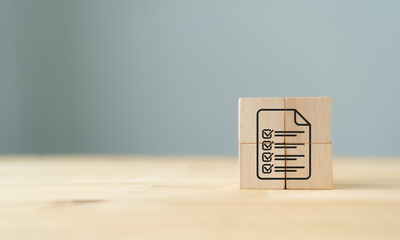 Paper document with check mark icon on wooden cube block. Quality control management, ISO...