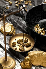 Vintage scales with gold nuggets on plastic stretch wrap