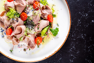 Beef tongue salad with fresh vegetables in plate