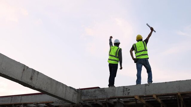 Construction engineers discussing project at construction site, Building construction collaboration concept, Video 4k slow motion.