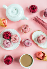 Close up view of delicious pink cupcakes with cup of coffee  on table