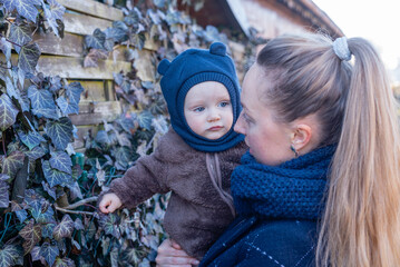 Obraz premium Woman holding baby in her hands. Mother and son. 