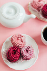 Close up view of delicious pink cupcakes with cup of coffee  on table