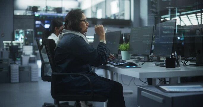 Diverse Young Indian Colleagues Working on Computers in a Research Laboratory. Focus on Female Software Developer Colleague Working on a Solution for Their Collaborative Industrial Tech Project